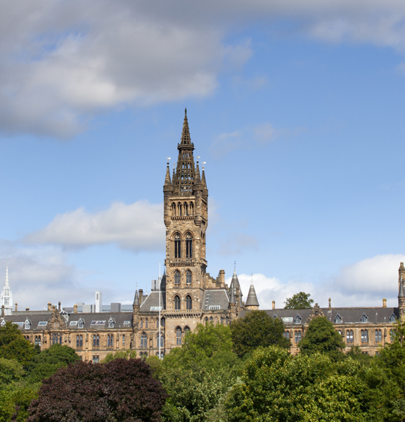 Exterior of University of Glasgow main building with main tower overlooking Kelvingrove park. 