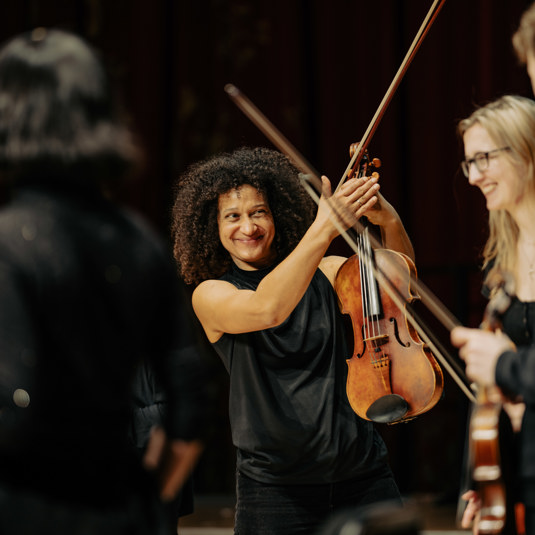 Smiling woman holds violin