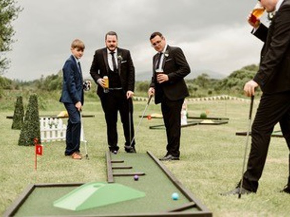 People playing mini golf outdoors