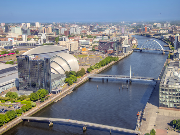 Aerial view of the River Clyde, with the Scottish Event Campus and glass tower of the Crowne Plaza hotel, with the city in the background