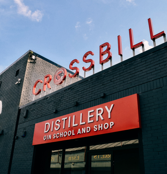 External view of distillery with Crossbill Distillery Gin School and Shop sign