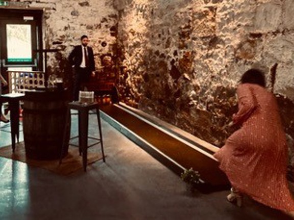 People playing ten pin bowling and giant connect four in an event setting