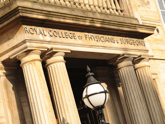 An exterior shot of 1599, showing the sandstone columns, lettering above the doorway reads, "Royal College of Physicians and Surgeons"