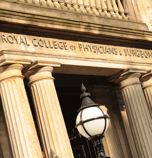 An exterior shot of 1599, showing the sandstone columns, lettering above the doorway reads, "Royal College of Physicians and Surgeons"