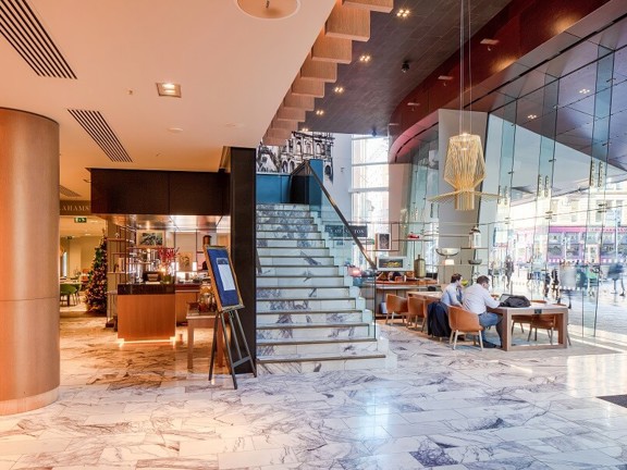 Marbled floor hotel reception area with floor to ceiling windows.