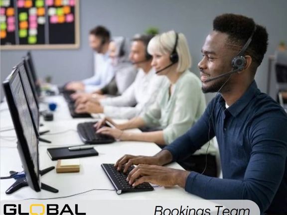 Five people sat in a row at desks in front of a computer each wearing a headset ready to take calls. Along the bottom it reads Global Language Services bookings team.