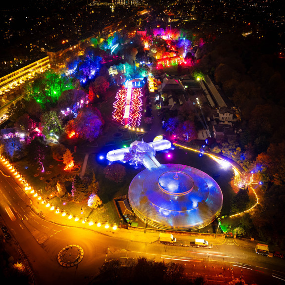 An aerial view of Botanics at night light up with oranges, purples, pinks, greens and blues for GlasGlow 