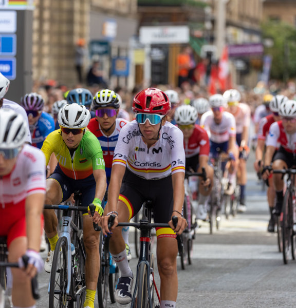 Group of professional cyclists riding through Glasgow city centre