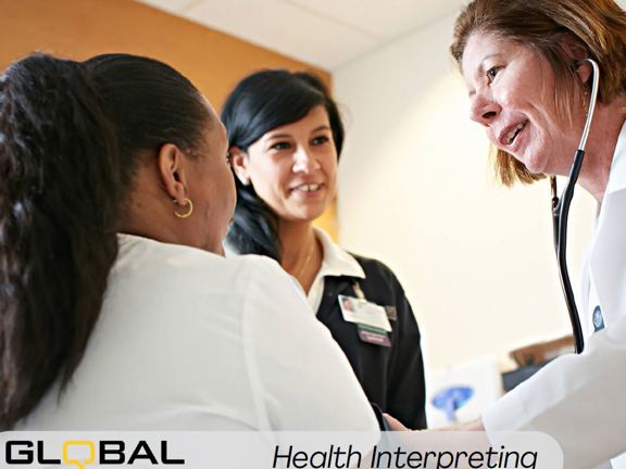 Three people in a group in a medical setting, one person wears and white coat and stethoscope around their neck. Another wears a navy jumper with an official id badge pinned to the front. The final person is sitting with their back to the camera. Along the bottom it reads Global Language Services Health Interpreting